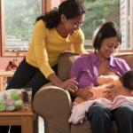 Breastfeeding Peer Counseling Mom Nursing on Couch 