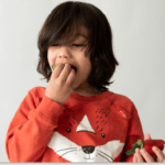 Toddler eating strawberries