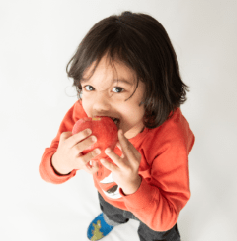 Toddler eating an apple