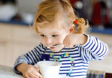 Young Girl Eating Yogurt